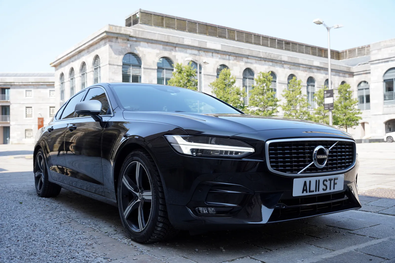 Comfort class saloon car outside Plymouth building